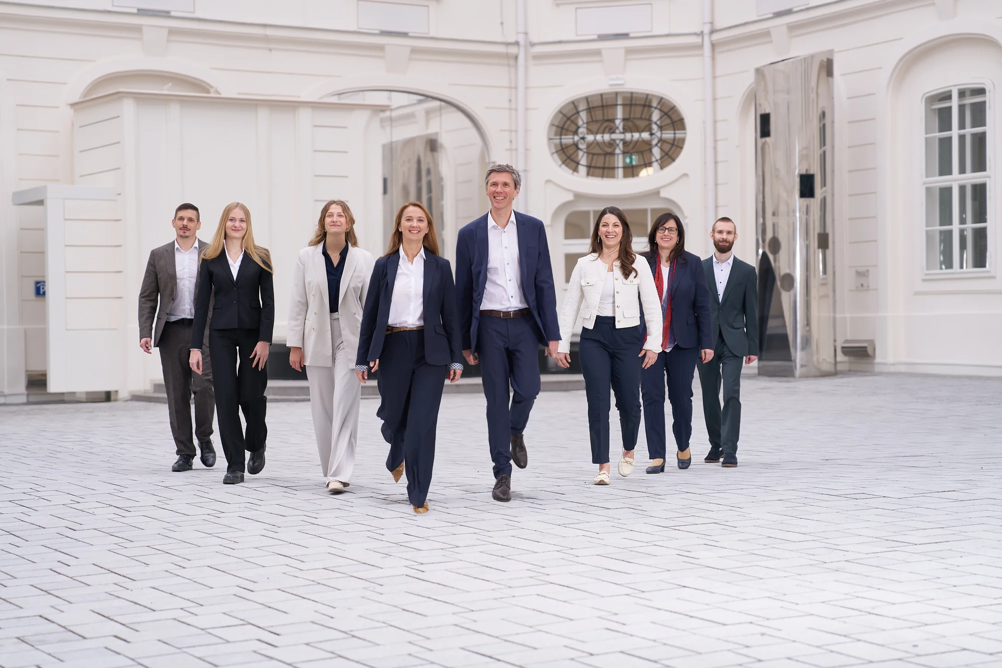 The loudspring management team in front of a bright Viennese building